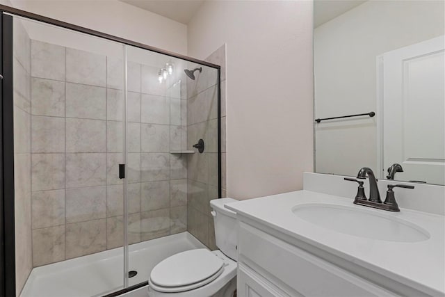 bathroom with vanity, toilet, and an enclosed shower