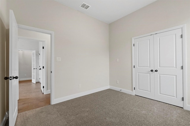 unfurnished bedroom featuring carpet flooring and a closet