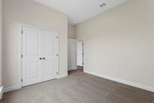 unfurnished bedroom with a closet and carpet