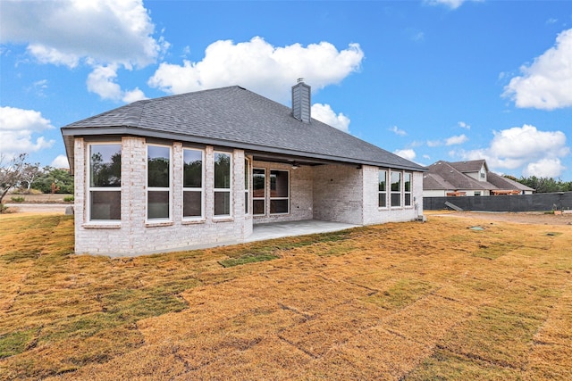 back of house featuring a yard and a patio area