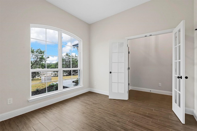 unfurnished room featuring dark hardwood / wood-style floors and french doors