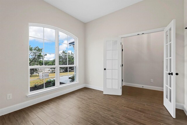 unfurnished bedroom with a towering ceiling, dark wood-type flooring, and a closet