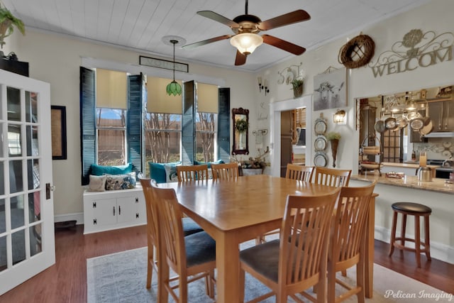 dining room with crown molding, wood ceiling, ceiling fan, and dark wood-type flooring