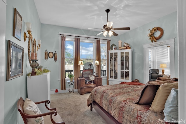 bedroom with ceiling fan and light carpet