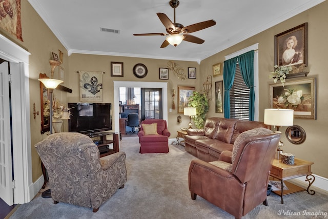 carpeted living room featuring ceiling fan and crown molding