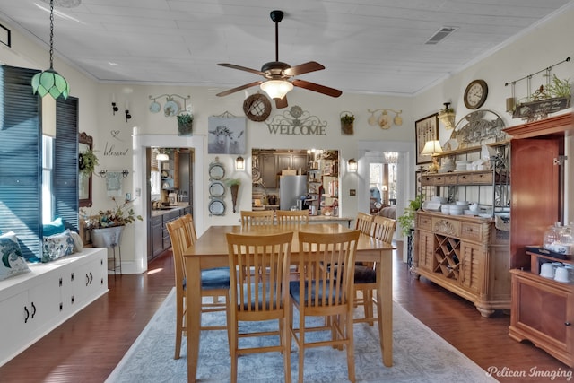 dining space with ceiling fan, crown molding, and dark hardwood / wood-style flooring