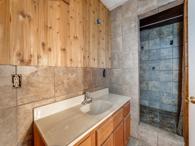 bathroom with tile walls and vanity