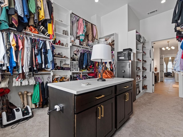 spacious closet featuring light colored carpet