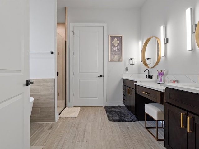 bathroom featuring shower with separate bathtub, vanity, and hardwood / wood-style floors