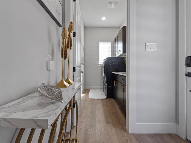 laundry area with light hardwood / wood-style flooring