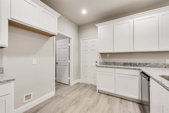 kitchen with light wood-type flooring, light stone countertops, dishwasher, and white cabinets