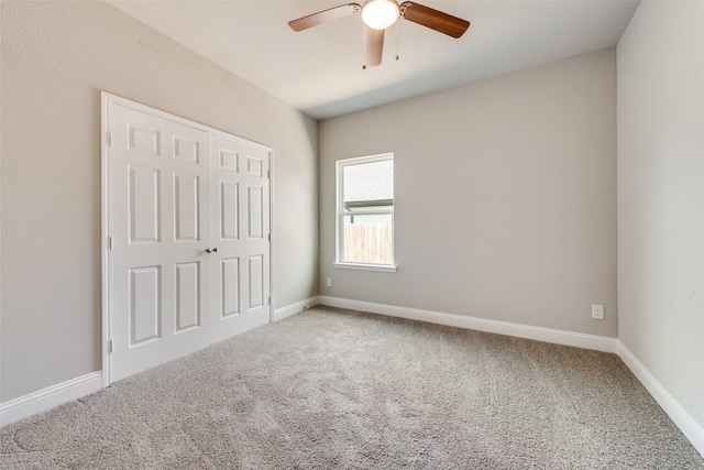 unfurnished bedroom with carpet flooring, ceiling fan, and a closet