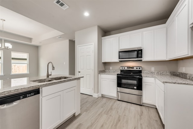 kitchen with light hardwood / wood-style floors, sink, stainless steel appliances, and white cabinets