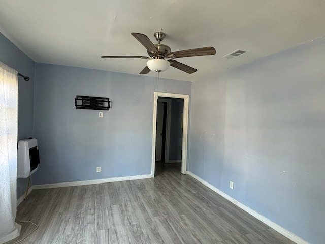 spare room featuring ceiling fan and hardwood / wood-style flooring