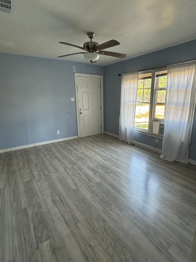 unfurnished room with ceiling fan and light hardwood / wood-style flooring