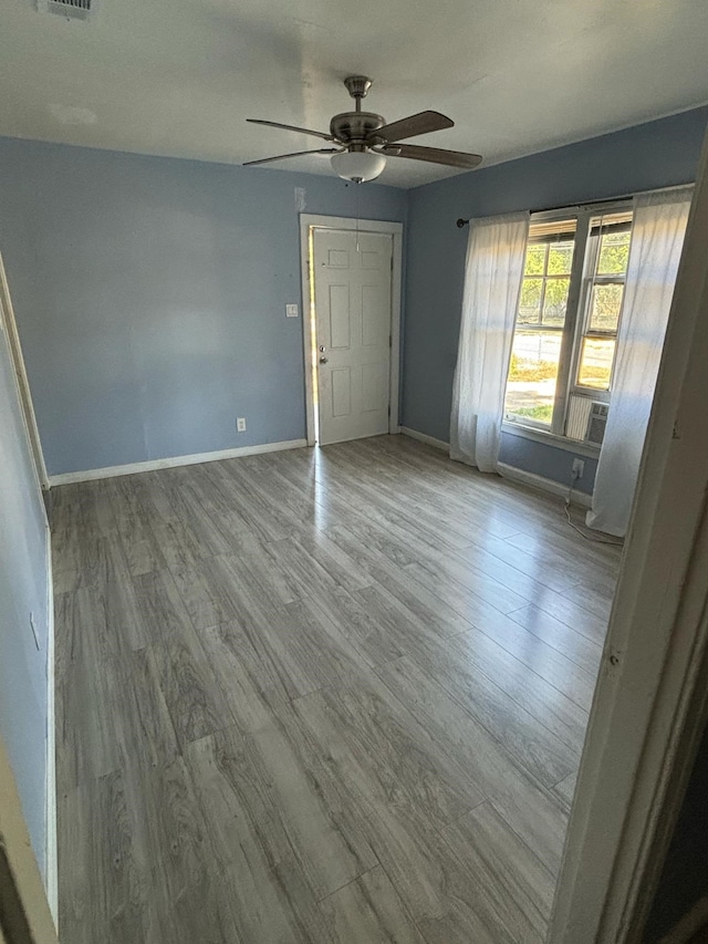 spare room with light hardwood / wood-style floors and ceiling fan