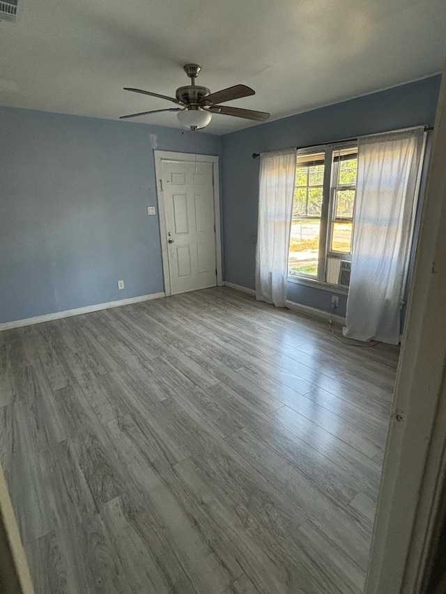 unfurnished room with light hardwood / wood-style flooring and ceiling fan