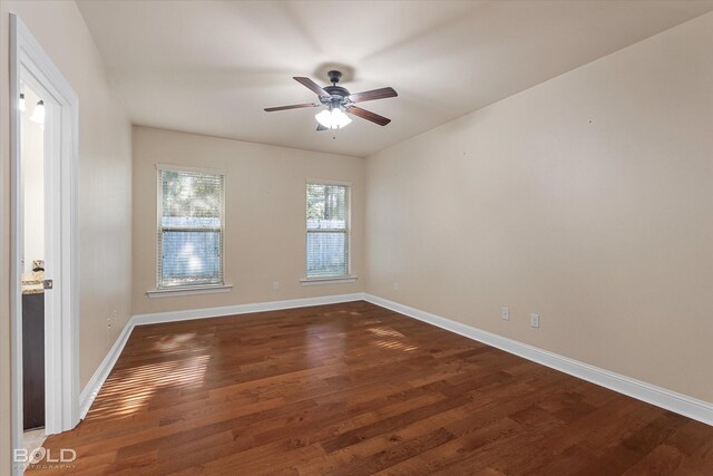 unfurnished room with ceiling fan and dark hardwood / wood-style flooring