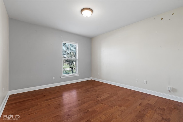 unfurnished room featuring dark hardwood / wood-style flooring