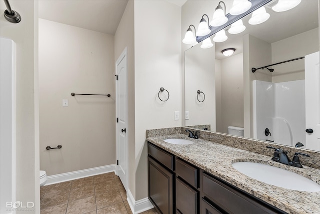 bathroom featuring vanity, toilet, and walk in shower