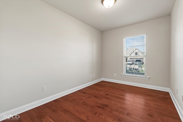 unfurnished room with wood-type flooring