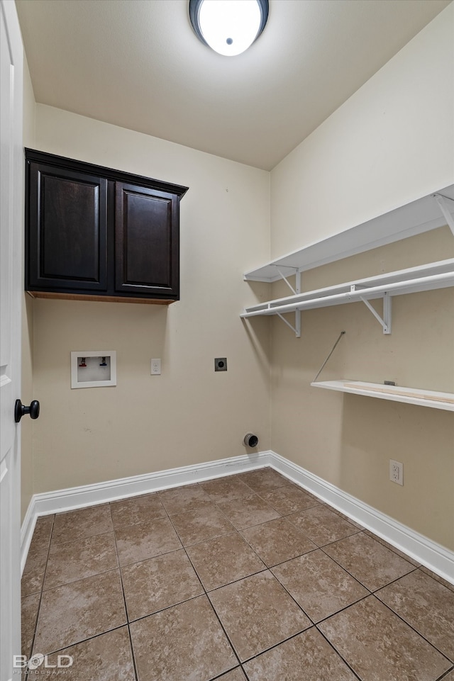 clothes washing area with hookup for an electric dryer, washer hookup, tile patterned flooring, and cabinets