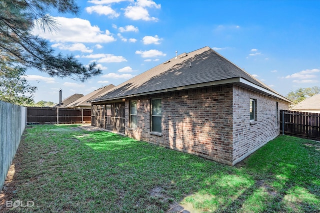 rear view of property featuring a yard