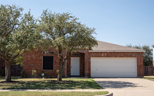 view of front of home with a front lawn and a garage