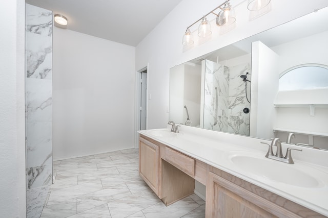 bathroom with vanity and a tile shower