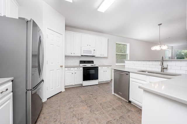 kitchen with sink, white cabinetry, hanging light fixtures, backsplash, and appliances with stainless steel finishes