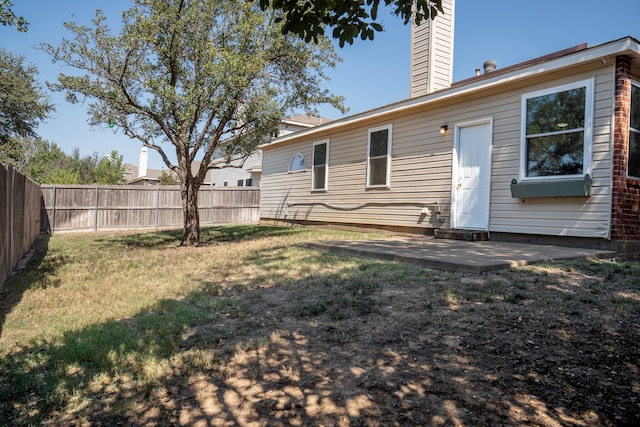 rear view of property with a lawn