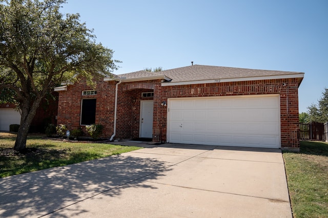 ranch-style house featuring a front lawn and a garage