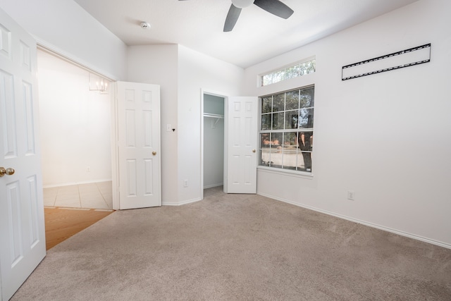 unfurnished bedroom featuring ceiling fan, light colored carpet, and a closet