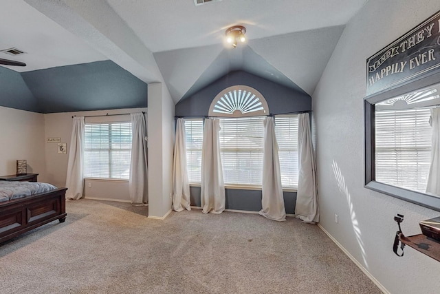 bedroom with vaulted ceiling and light colored carpet