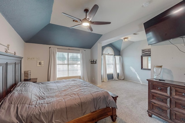 carpeted bedroom featuring ceiling fan and vaulted ceiling