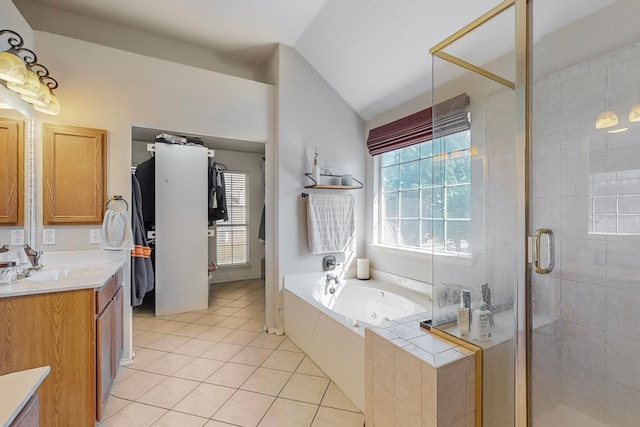 bathroom with vaulted ceiling, vanity, tile patterned flooring, and separate shower and tub