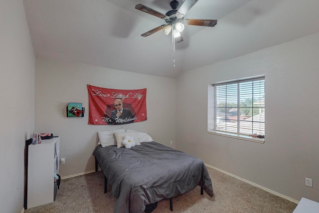 bedroom with ceiling fan, vaulted ceiling, and carpet