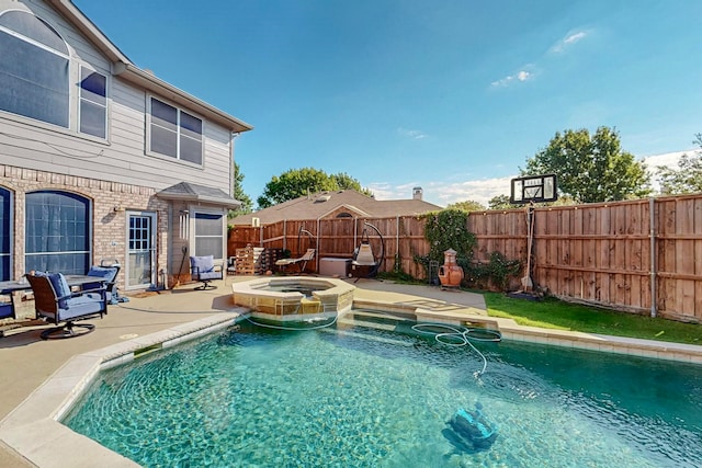 view of swimming pool with an in ground hot tub and a patio area