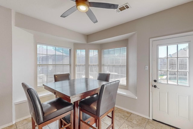 dining area with ceiling fan, light tile patterned flooring, and a healthy amount of sunlight