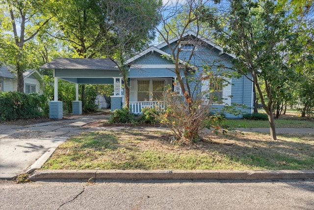 view of front of home featuring covered porch and a carport