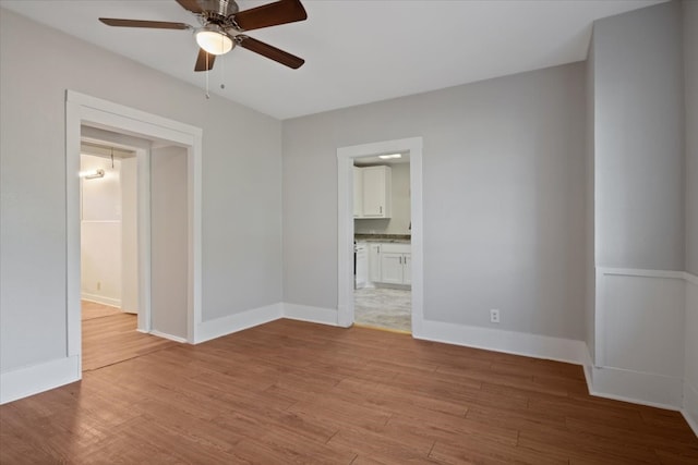 empty room with light hardwood / wood-style floors and ceiling fan