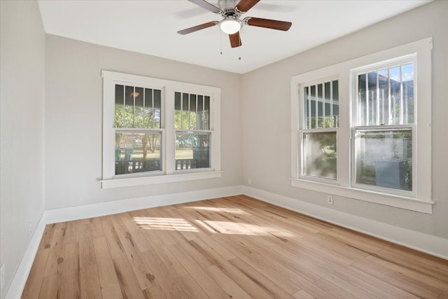 spare room with light hardwood / wood-style flooring, ceiling fan, and plenty of natural light