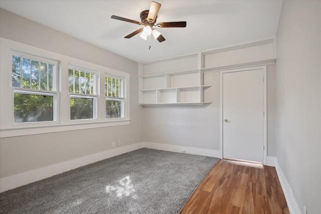 empty room with ceiling fan and hardwood / wood-style flooring