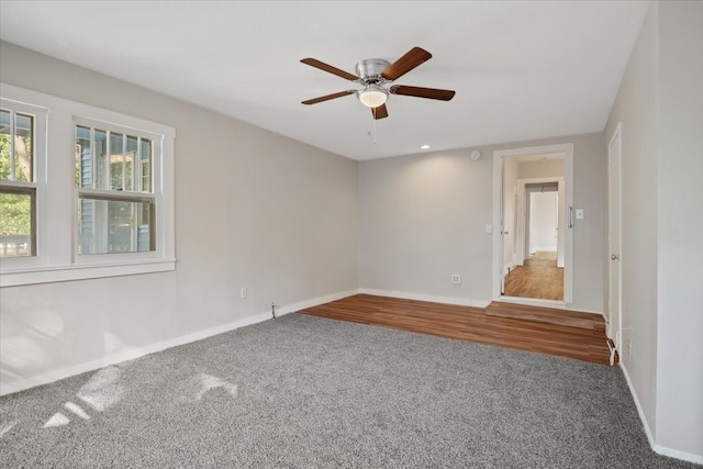 unfurnished room with ceiling fan and hardwood / wood-style flooring