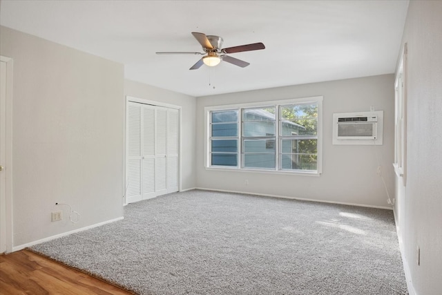 unfurnished bedroom with wood-type flooring, ceiling fan, a wall mounted air conditioner, and a closet