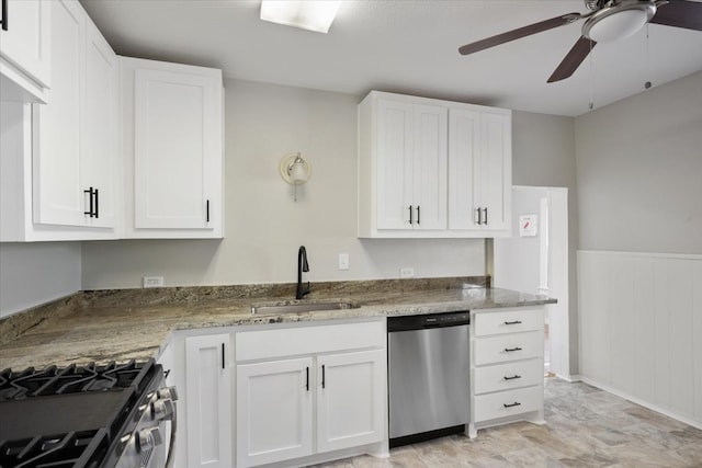 kitchen with light stone counters, white cabinets, ceiling fan, sink, and stainless steel appliances