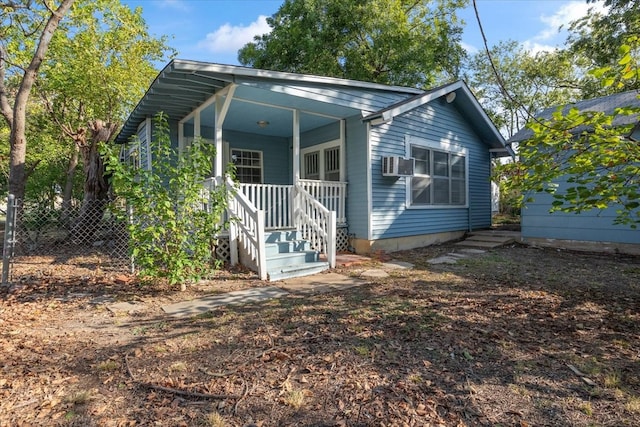 rear view of property featuring cooling unit and covered porch