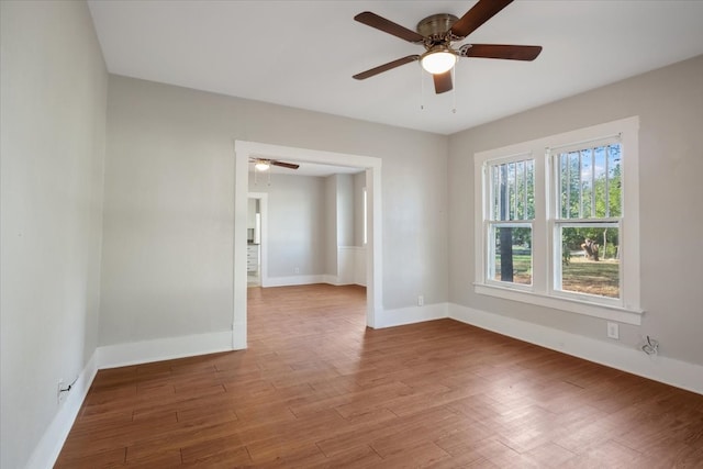 empty room with ceiling fan and light wood-type flooring