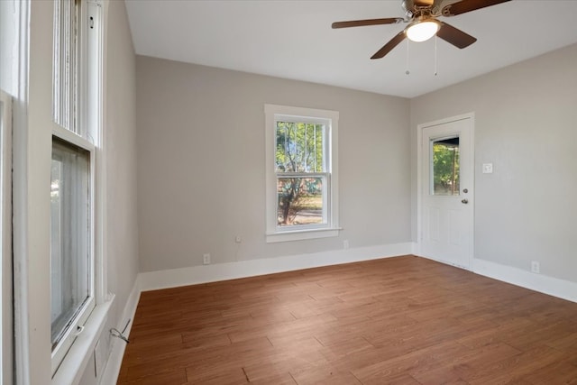 spare room featuring wood-type flooring and ceiling fan