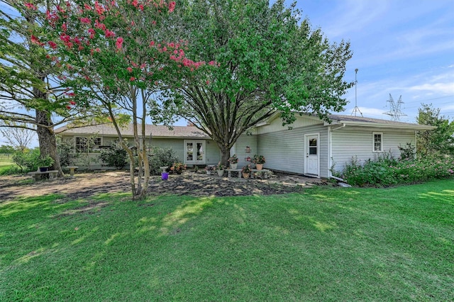 back of house with a lawn